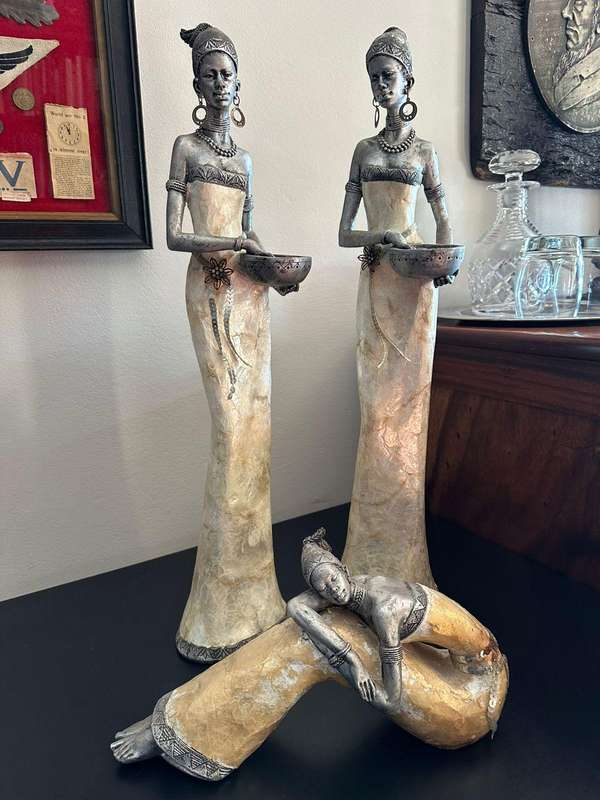 Three decorative composite moulded figurines,decorated with applied mother of pearl. Height of talle