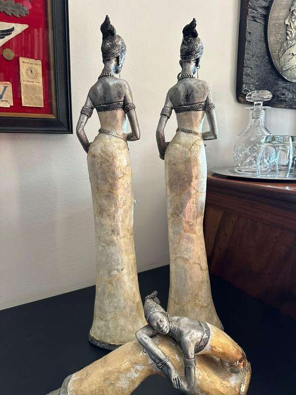 Three decorative composite moulded figurines,decorated with applied mother of pearl. Height of talle