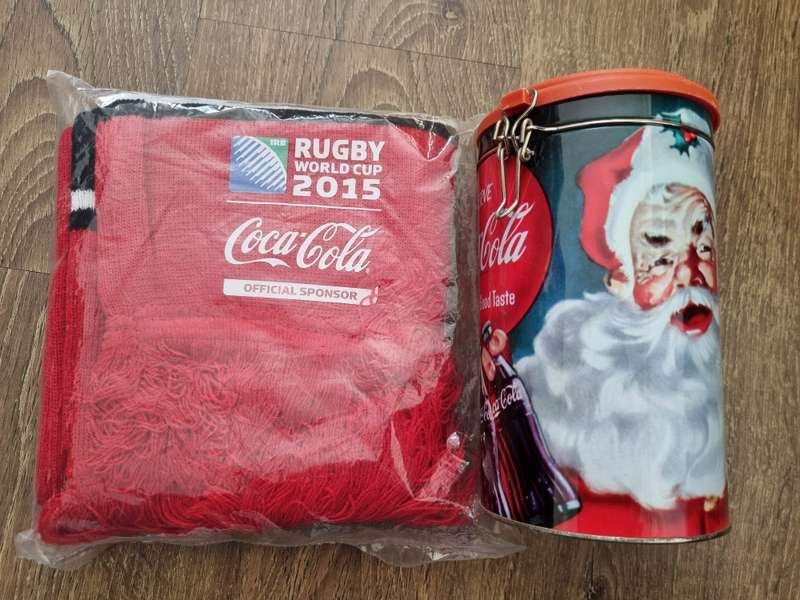 Coca Cola branded gift tin and rugby scarf.