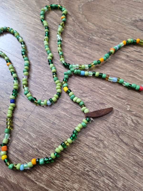 Wooden Statuette - Man playing instrument & Beaded necklace.