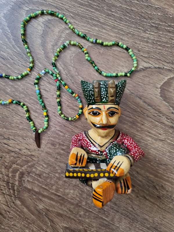 Wooden Statuette - Man playing instrument & Beaded necklace.