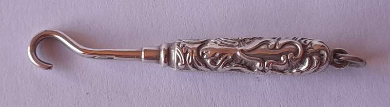 Edwardian All Solid Silver Miniature Glove Hook Pendant. Adie & Lovekin, Birmingham.