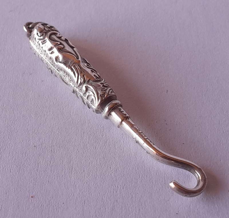 Edwardian All Solid Silver Miniature Glove Hook Pendant. Adie & Lovekin, Birmingham.