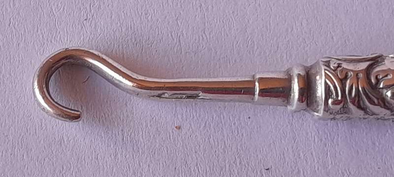 Edwardian All Solid Silver Miniature Glove Hook Pendant. Adie & Lovekin, Birmingham.