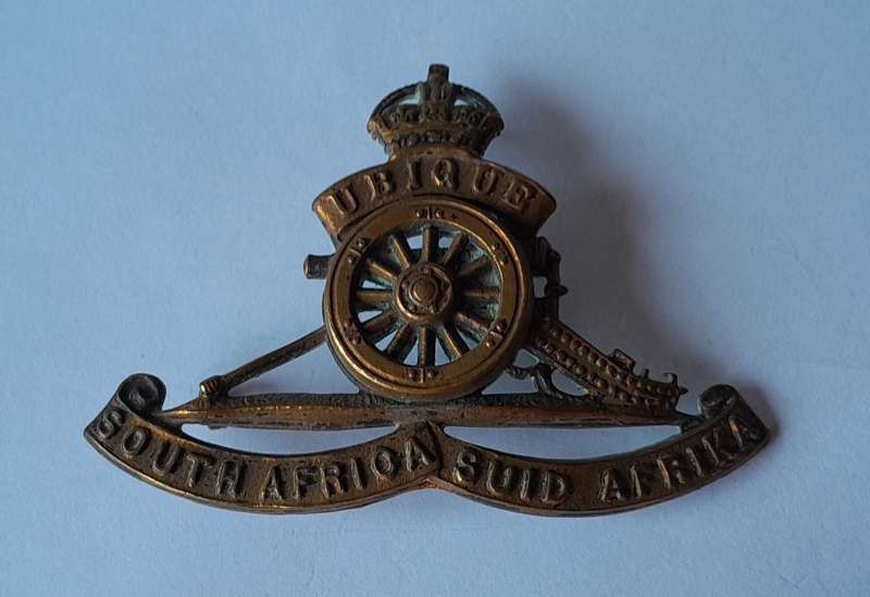 WW2 SA Field Artillery Cap Badge.  (Rotating Wheel).  2 Lugs Intact.