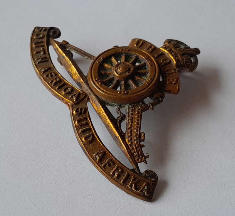 WW2 SA Field Artillery Cap Badge.  (Rotating Wheel).  2 Lugs Intact.