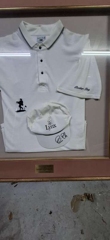 Framed Ernie Els golf shirt and signed cap