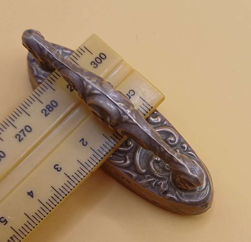Marked silver nail buffer lion facing left