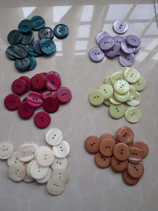 Buttons-- 1635 assorted plastic buttons.