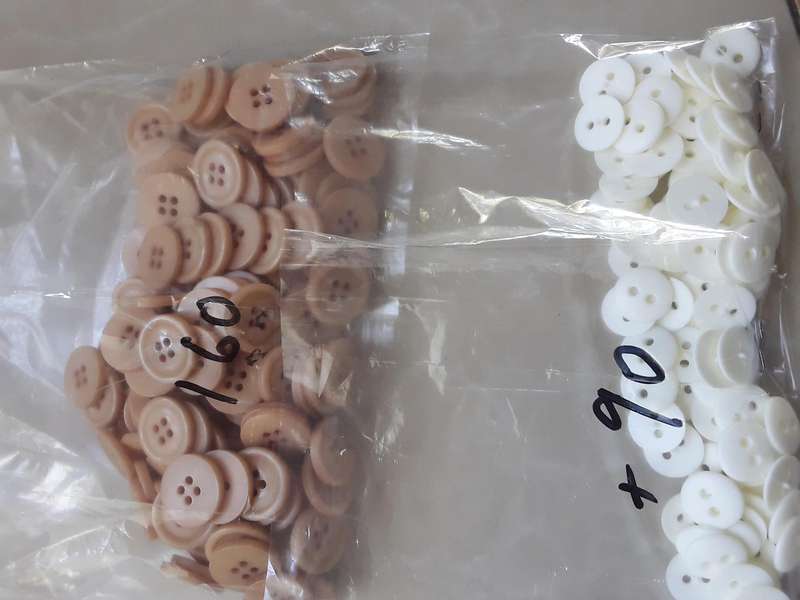 Buttons-- 1075 assorted plastic buttons.