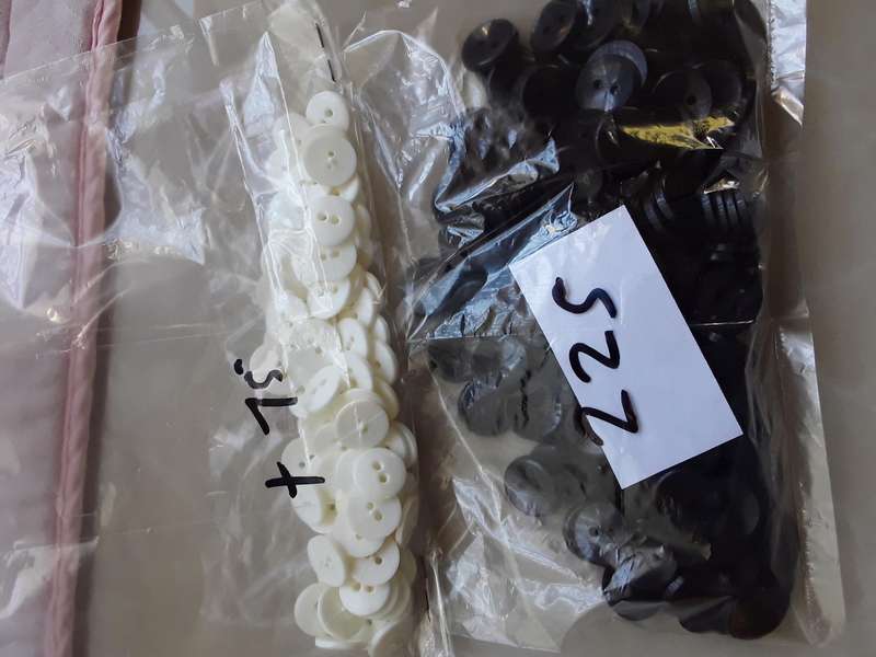 Buttons-- 1075 assorted plastic buttons.