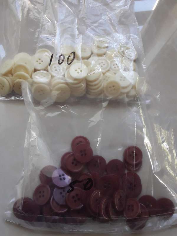 Buttons-- 1075 assorted plastic buttons.