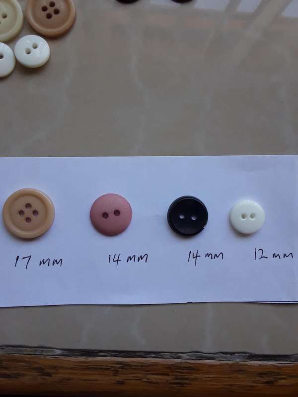 Buttons-- 1075 assorted plastic buttons.
