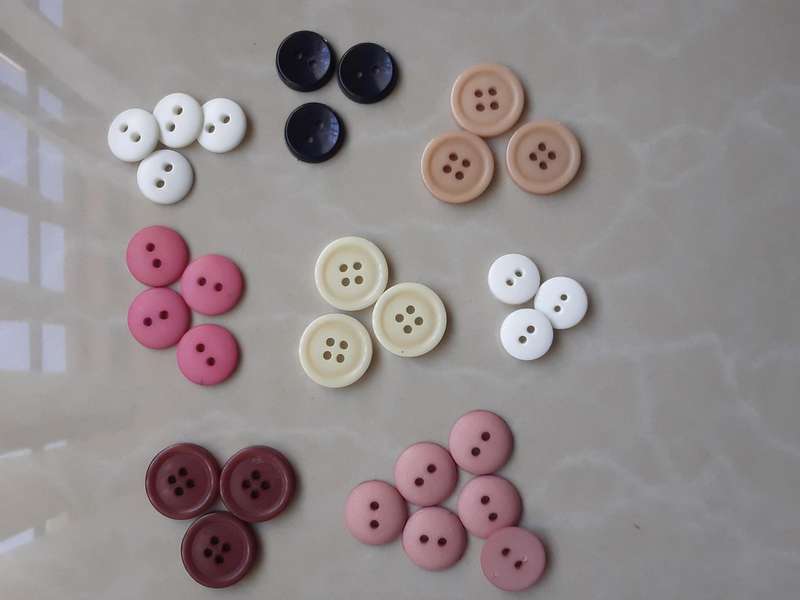Buttons-- 1075 assorted plastic buttons.