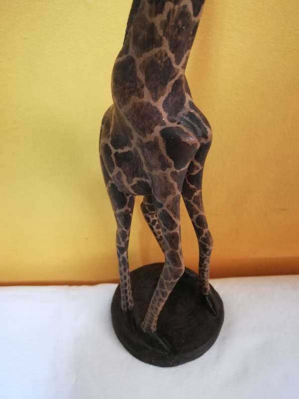 Beautiful handcarved Giraffe from Kenya. Handmade by artisans from a single block of wood.