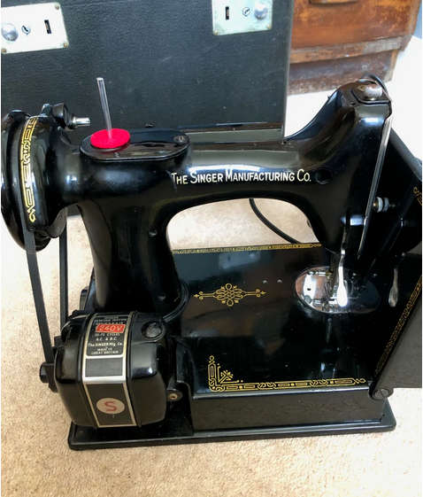 Vintage Singer Featherweight 221K1 portable sewing machine with case.