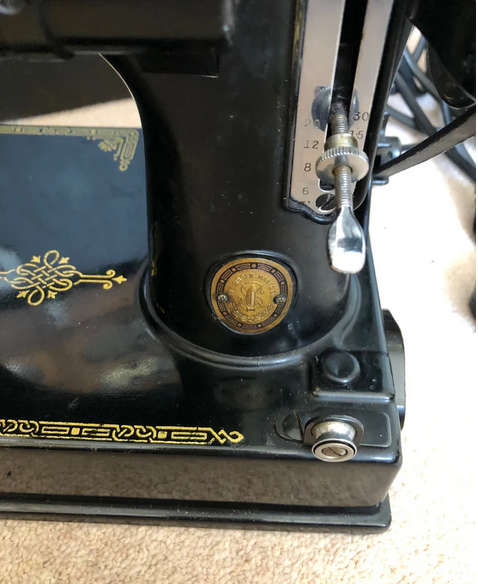 Vintage Singer Featherweight 221K1 portable sewing machine with case.