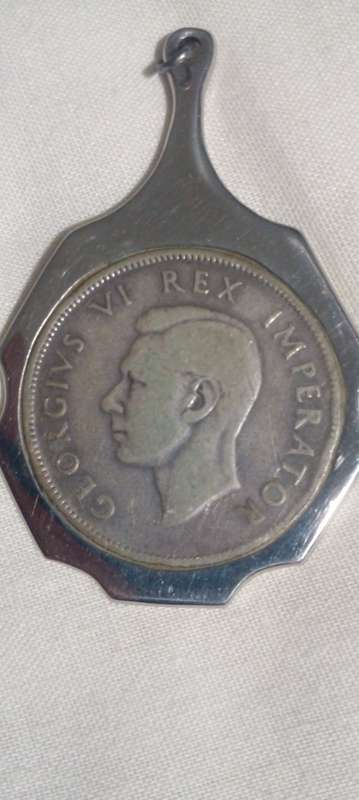 1942  UNION OF SA SILVER HALFCROWN TURNED INTO A PENDANT TOTAL WEIGHT 20.8 GRAMS..