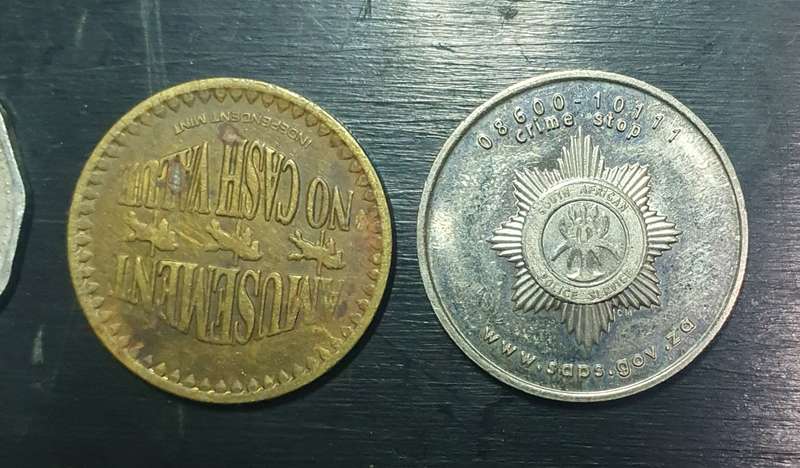 Collection of 4 tokens including a Van Reebeck & a SAPS coin by Coin World