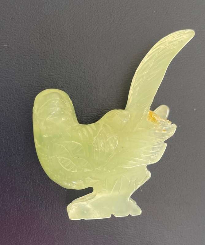 Vintage -Intricately etched pale green stone bird with broken wing