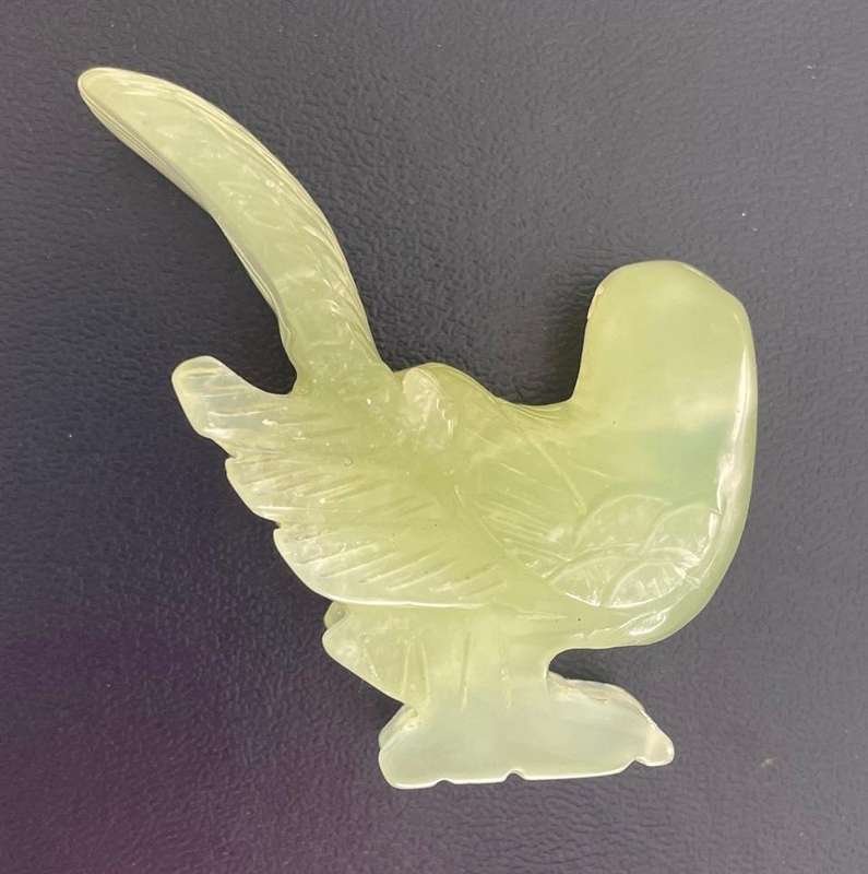 Vintage -Intricately etched pale green stone bird with broken wing