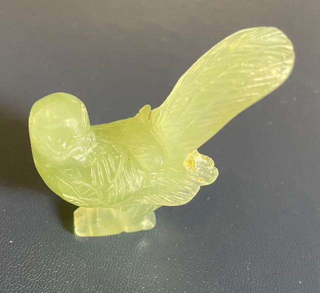 Vintage -Intricately etched pale green stone bird with broken wing