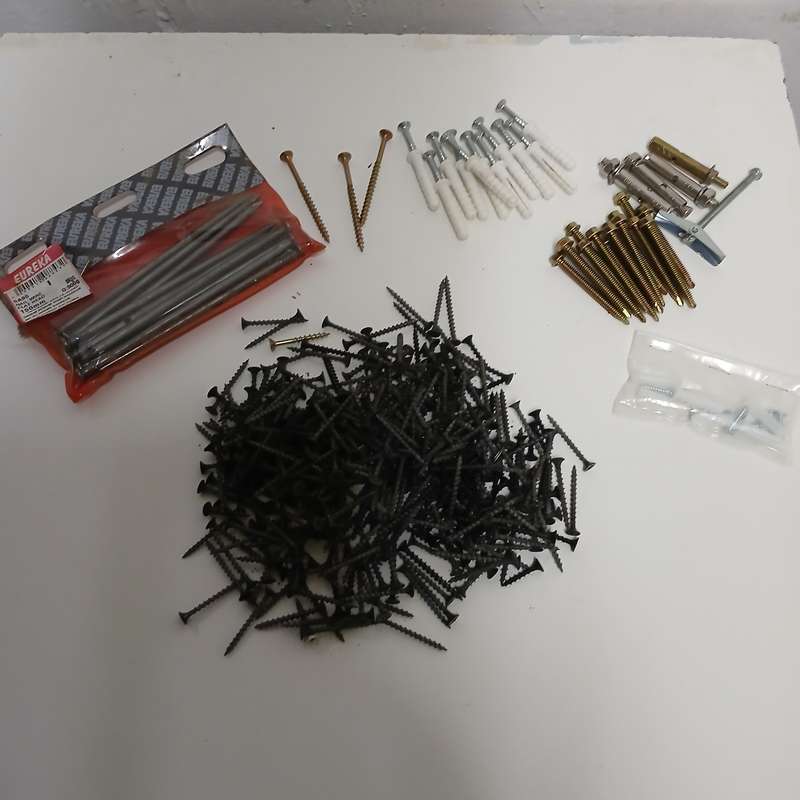 assortment of fasteners, primarily screws and nails