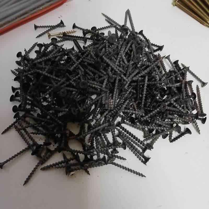 assortment of fasteners, primarily screws and nails
