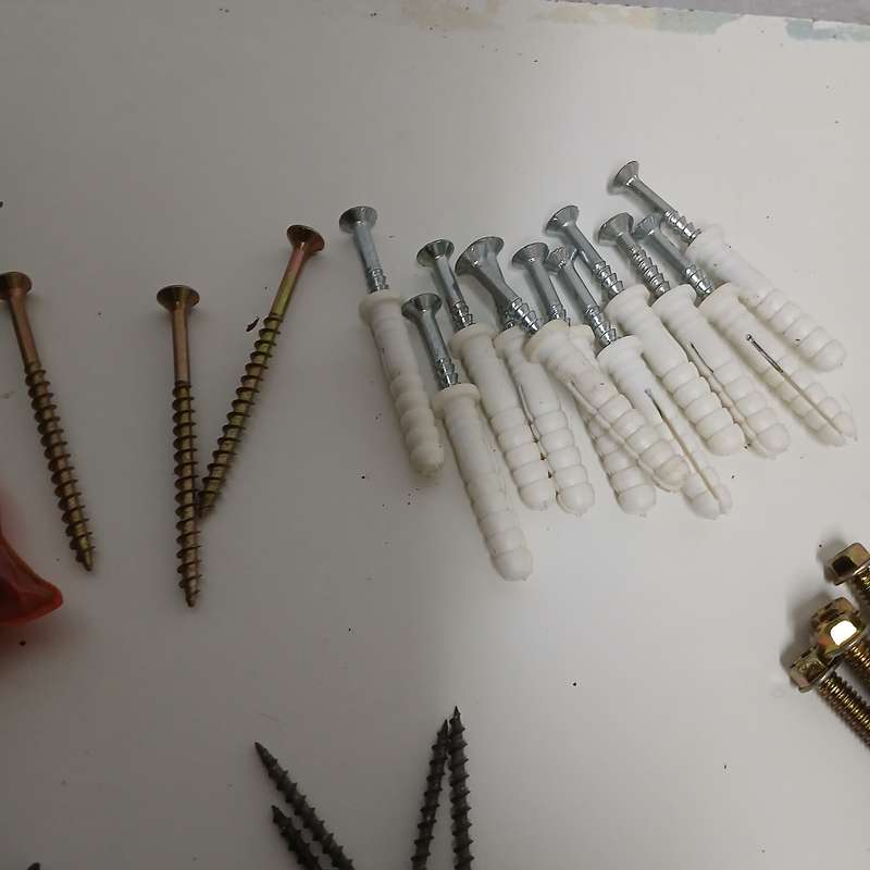 assortment of fasteners, primarily screws and nails