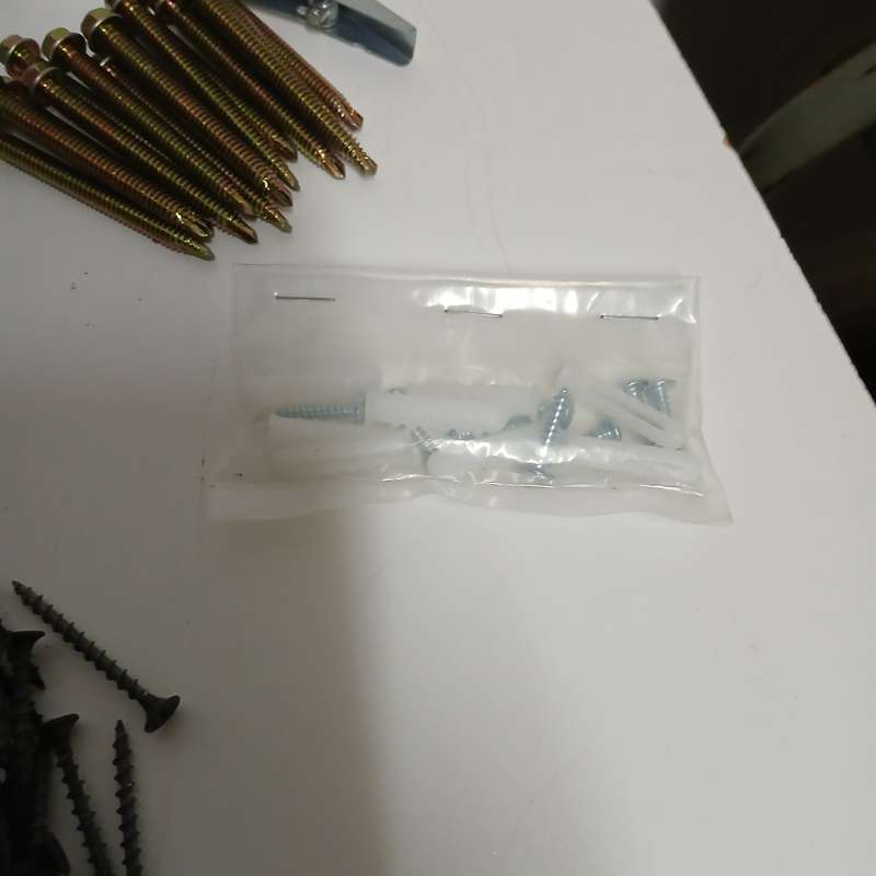 assortment of fasteners, primarily screws and nails
