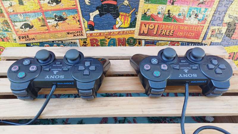 Playstation 2 - Black Slim c/w 2 x Controllers, AV Cable & Power Cord + 4 Games