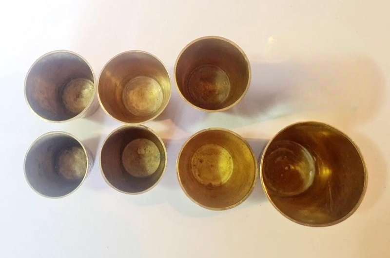 7 brass shot glasses. Various sizes