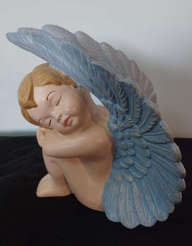 Vintage ceramic sleeping angel in wings