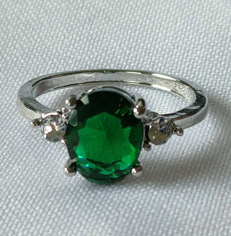 Lovely red lab-created green stone ring in a lovely setting