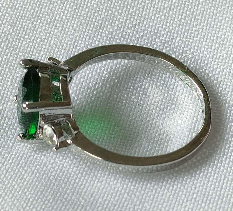 Lovely red lab-created green stone ring in a lovely setting