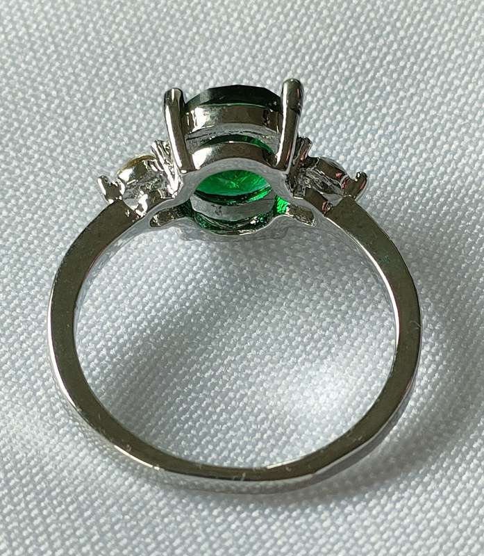 Lovely red lab-created green stone ring in a lovely setting