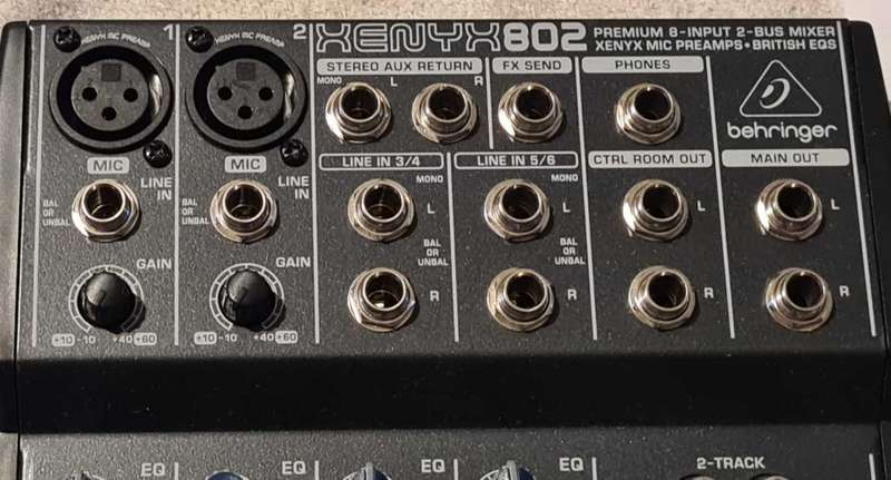 Behringer Xenyx 802 audio mixer. It's a compact, 8-input mixer.