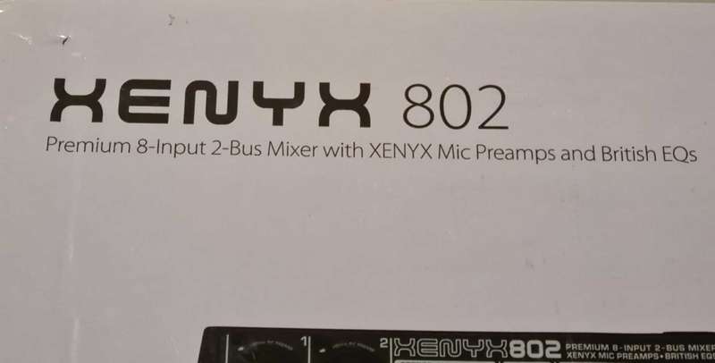 Behringer Xenyx 802 audio mixer. It's a compact, 8-input mixer.