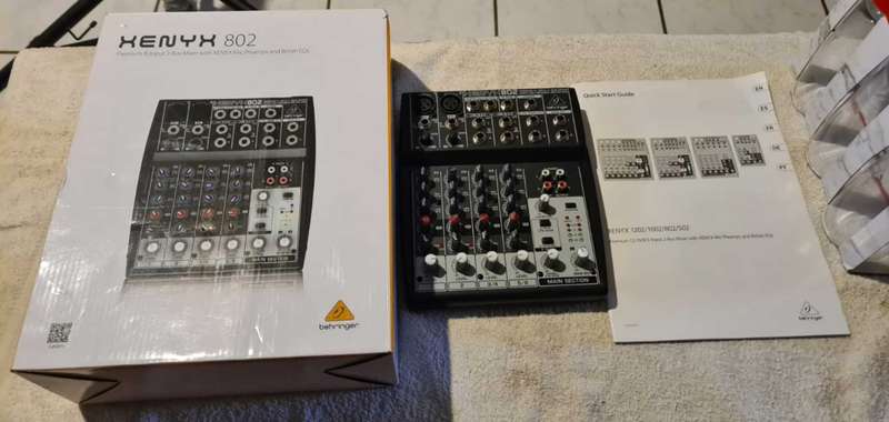 Behringer Xenyx 802 audio mixer. It's a compact, 8-input mixer.