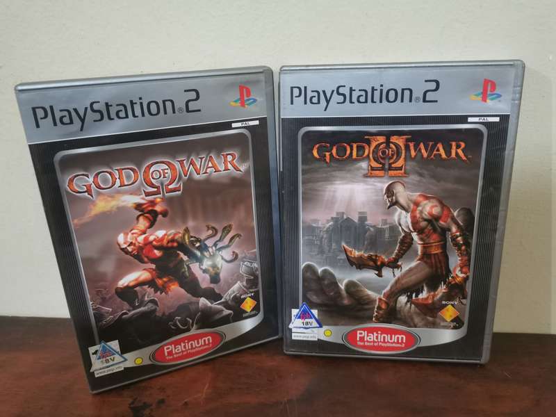 God of War 1 and 2 on PlayStation 2 with booklets