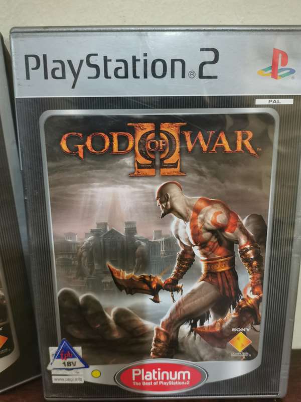 God of War 1 and 2 on PlayStation 2 with booklets