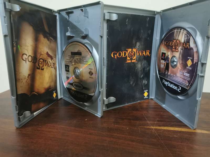 God of War 1 and 2 on PlayStation 2 with booklets