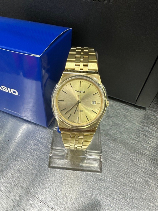 Casio MTP analog gold-tone wristwatch.