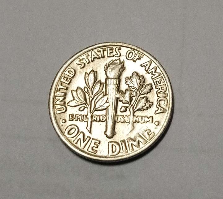 1985 (D) one dime with mint errors in the front on the rim and lettering on "we"
