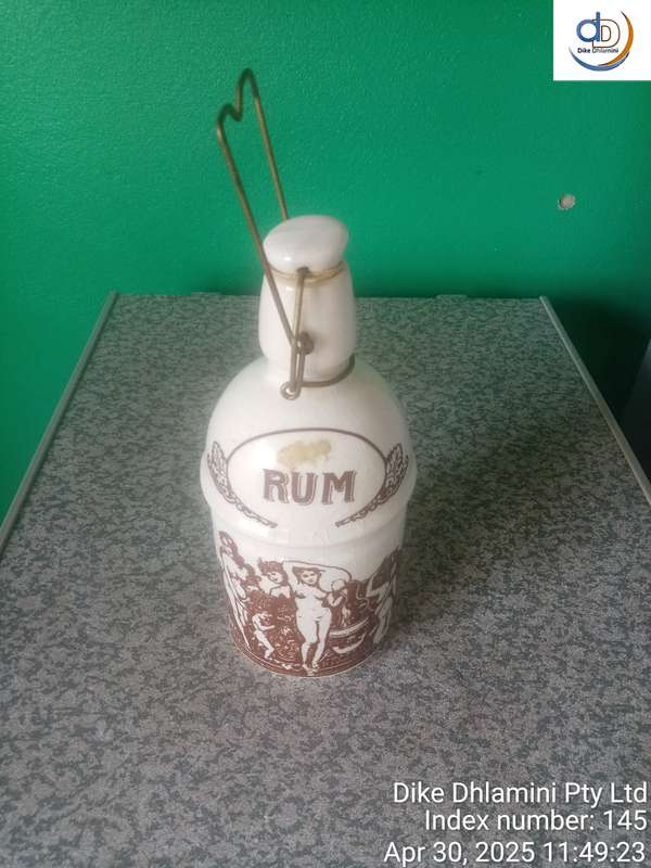Vintage stoneware "RUM" crock specifically identified as East India Rum crock