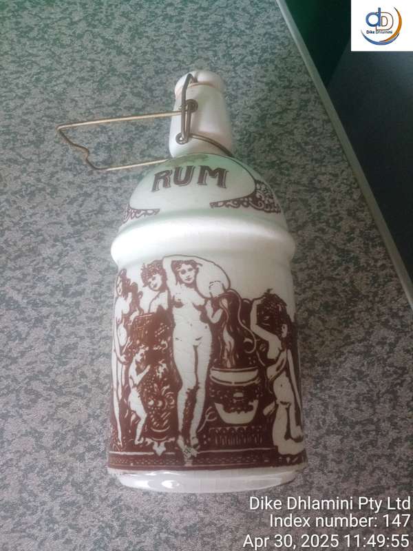 Vintage stoneware "RUM" crock specifically identified as East India Rum crock