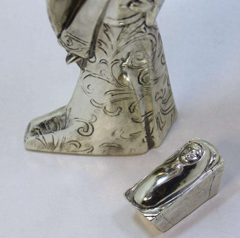 Figurine Of The Angel Gabriel Looking Over Baby Jesus In The Manger
