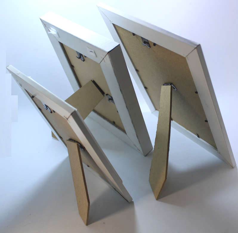 Three Various Sized White Photo Frames With Stands