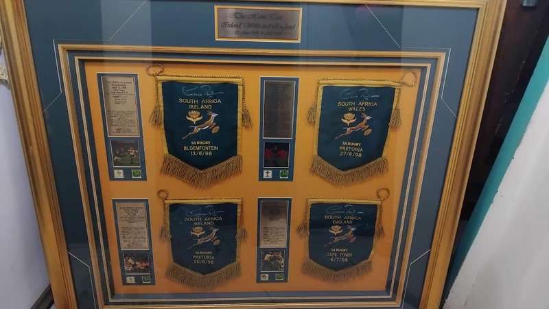 Framed sports memorabilia displays and commemorative plaques