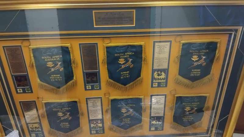Framed sports memorabilia displays and commemorative plaques